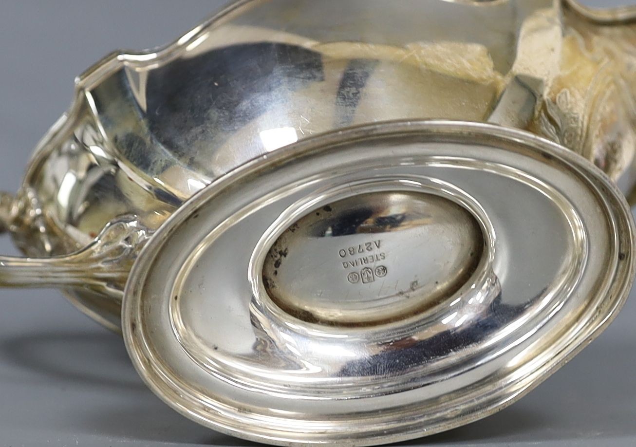 An American sterling sauceboat, a silver cream jug, a modern silver commemorative letter opener and three other items.